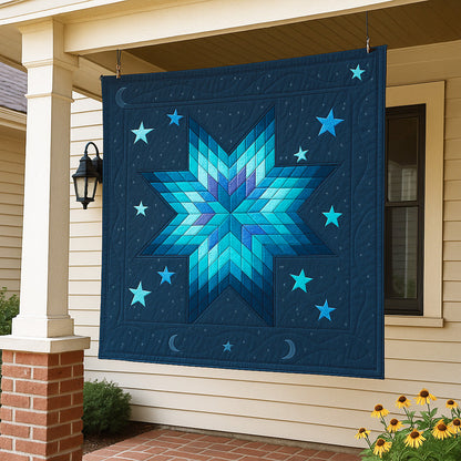 The Aurora Nightscape Downloadable PDF Quilt Pattern, featuring blue and teal moons and stars, is displayed on the porch of a house with beige siding and brick columns.