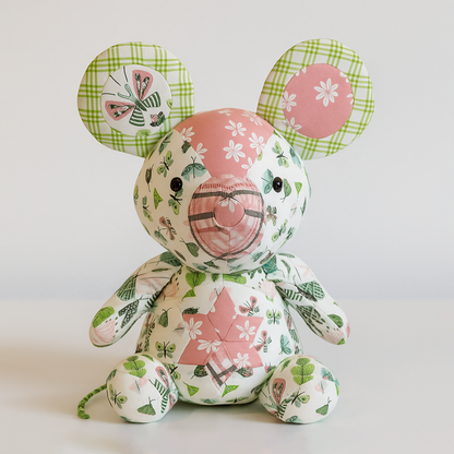 Momo the Mouse Downloadable PDF Quilt Pattern lets you sew a charming patchwork mouse toy with big ears, crafted from pink, green, and white floral and plaid fabrics—a delightful quilting gift for any sewing enthusiast.