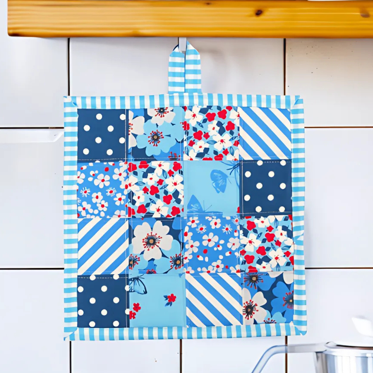 The Pot Holder Downloadable PDF Quilt Pattern features blue, white, and red floral, polka dot, and striped designs—an ideal beginner quilting project to brighten any kitchen.